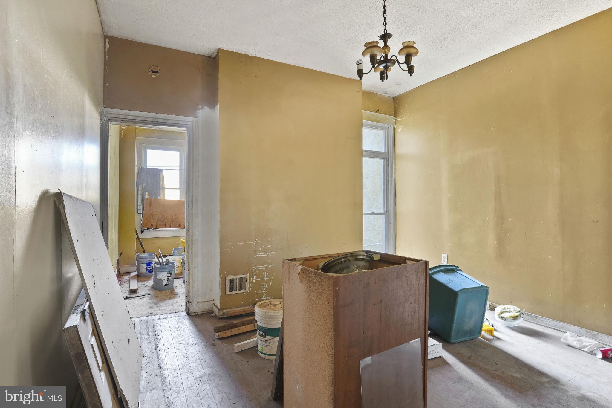 2121 Division Street Baltimore, MD 21217 - Photo 5 of 18 a dining room with furniture and a chandelier