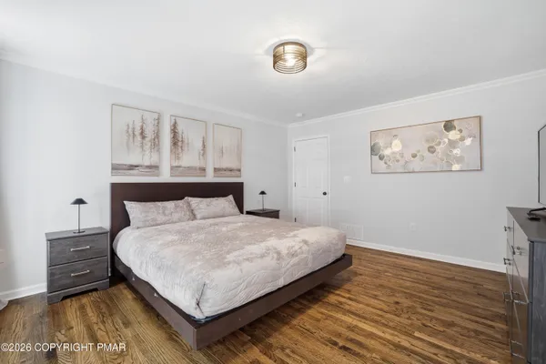 a large bed sitting in a bedroom next to a window
