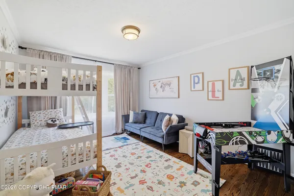 a living room with furniture and painting on the wall next to a window