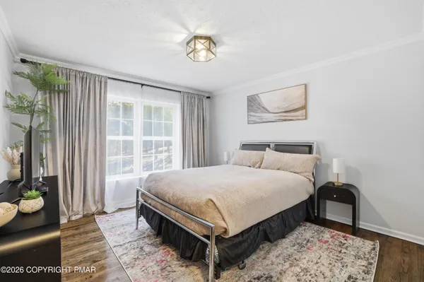 a bedroom with a bed lamp and a window