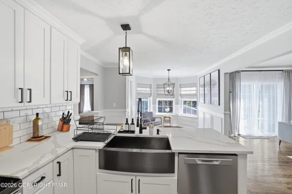 a kitchen with a sink a stove and cabinets