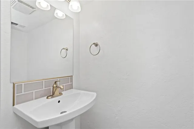 a bathroom with a sink and mirror