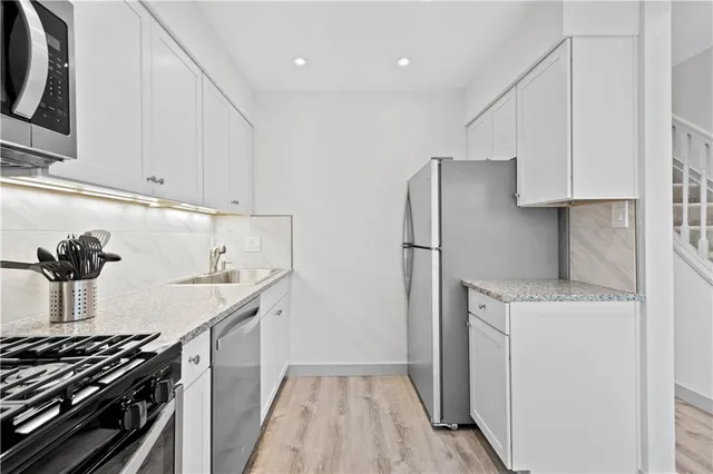 a kitchen with a sink and a stove top oven