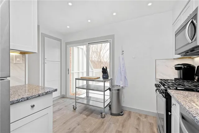 a kitchen with granite countertop a stove and a refrigerator