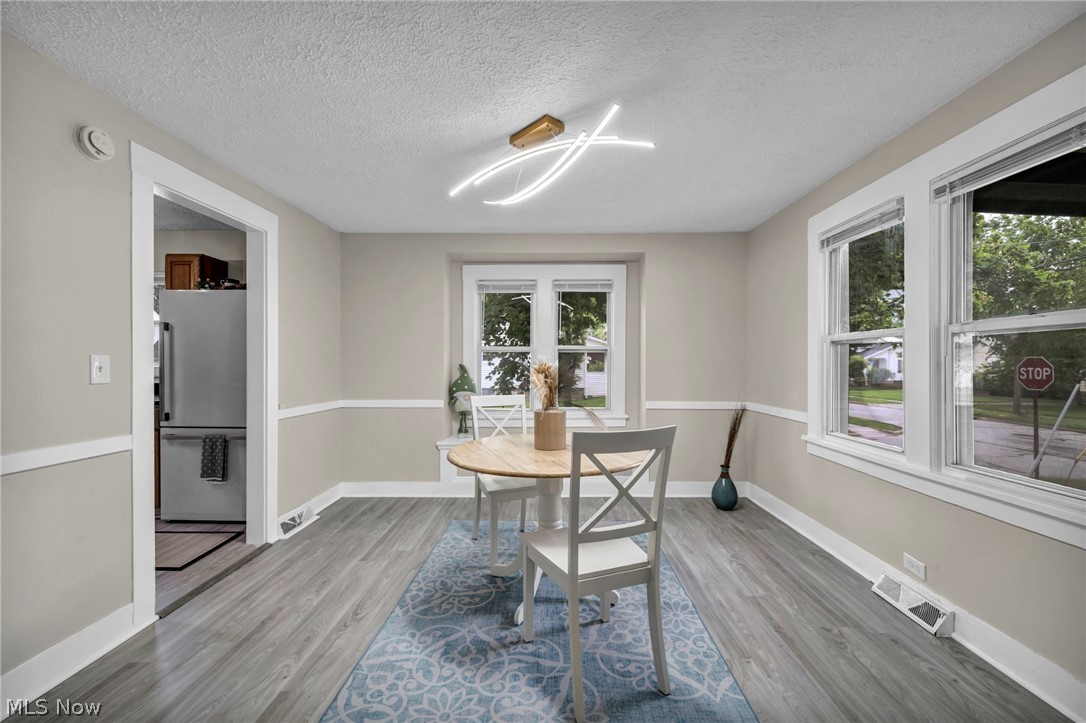 1603 Winchester Road Lyndhurst, OH 44124 - Photo 10 of 34 Bright and inviting dining space featuring new flooring and updated lighting that creates the perfect setting for everyday meals or hosting guests.