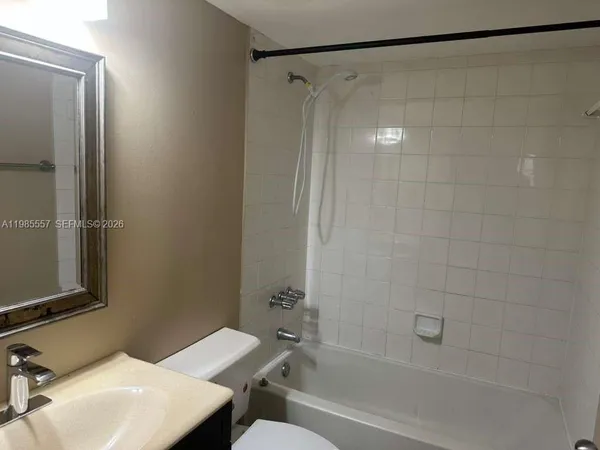 a bathroom with a sink toilet vanity and bathtub