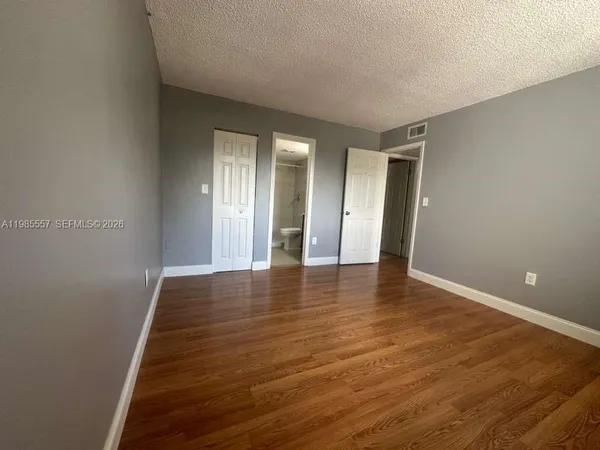 a kitchen with stainless steel appliances granite countertop a stove microwave and refrigerator