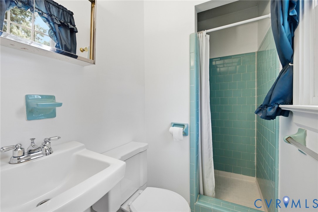 10215 River Road Petersburg, VA 23803 - Photo 23 of 31 Bathroom featuring a shower with teal subway tile,