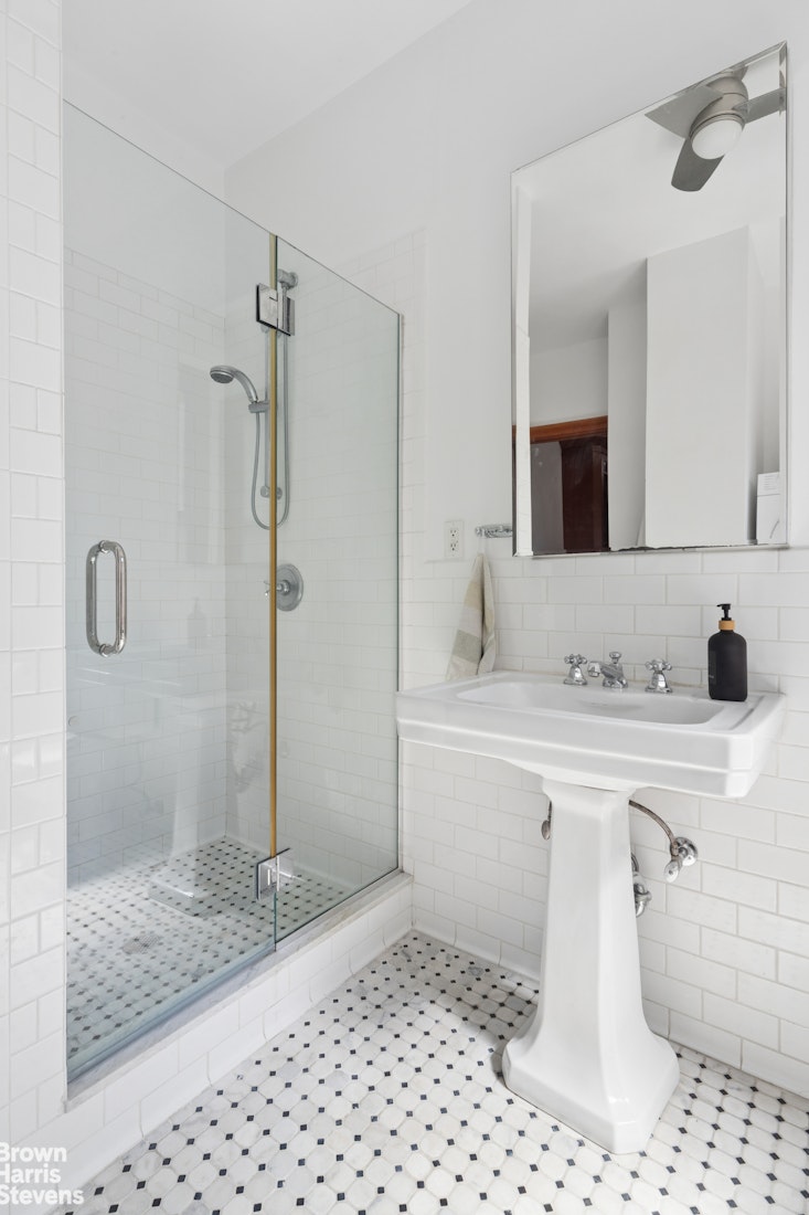 790 Riverside Drive, Unit 4J Manhattan, NY 10032 - Photo 5 of 11 a bathroom with a sink and a mirror