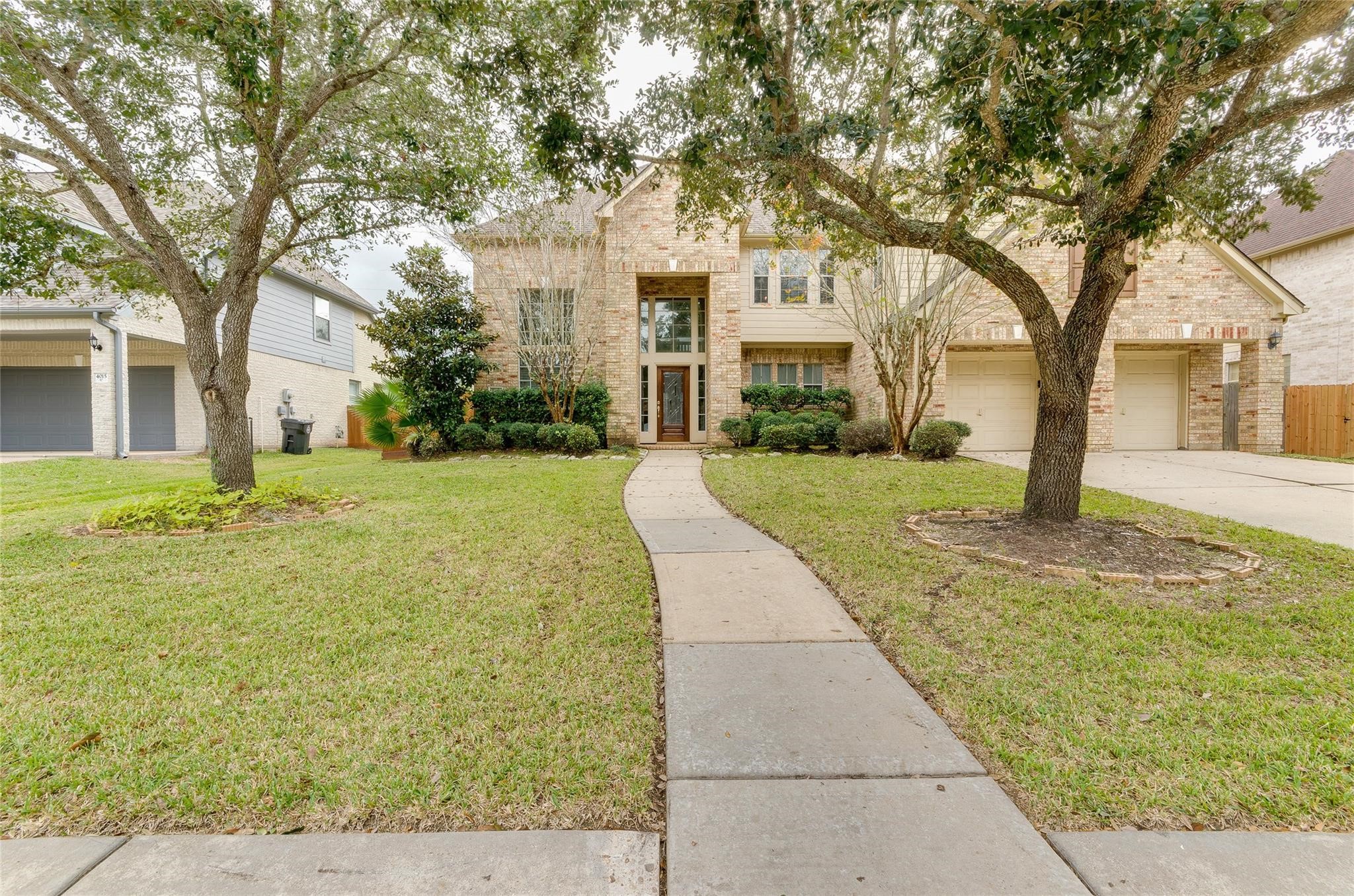 4019 Angel Spring Drive Sugar Land, TX 77479 - Photo 49 of 50 a front view of a house with a yard and trees