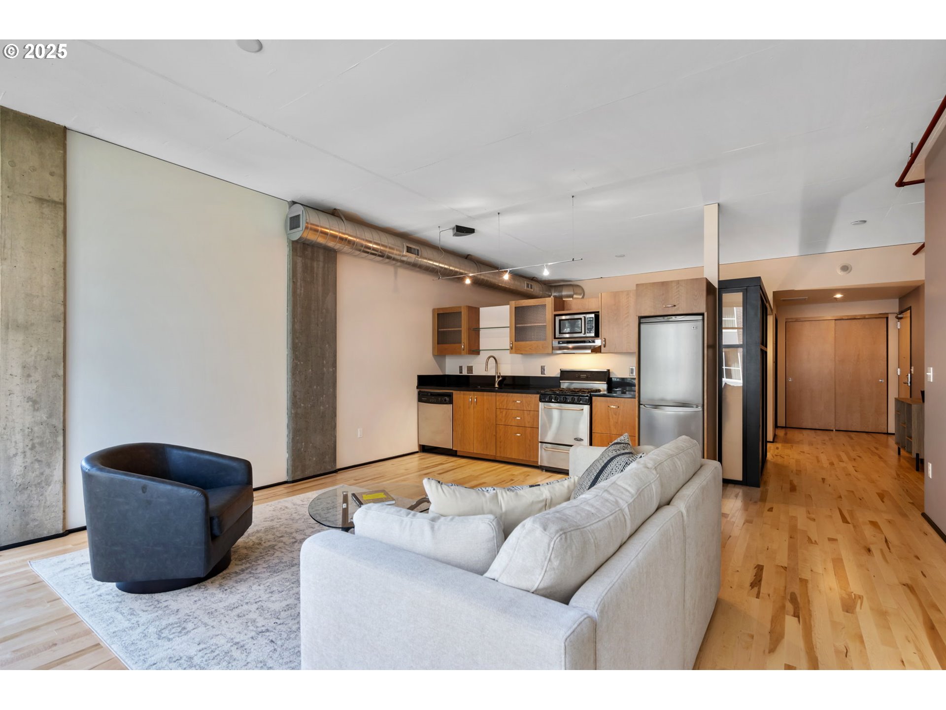 333 Northwest 9th Avenue, Unit 411 Portland, OR 97209 - Photo 13 of 32 a living room with furniture and kitchen view
