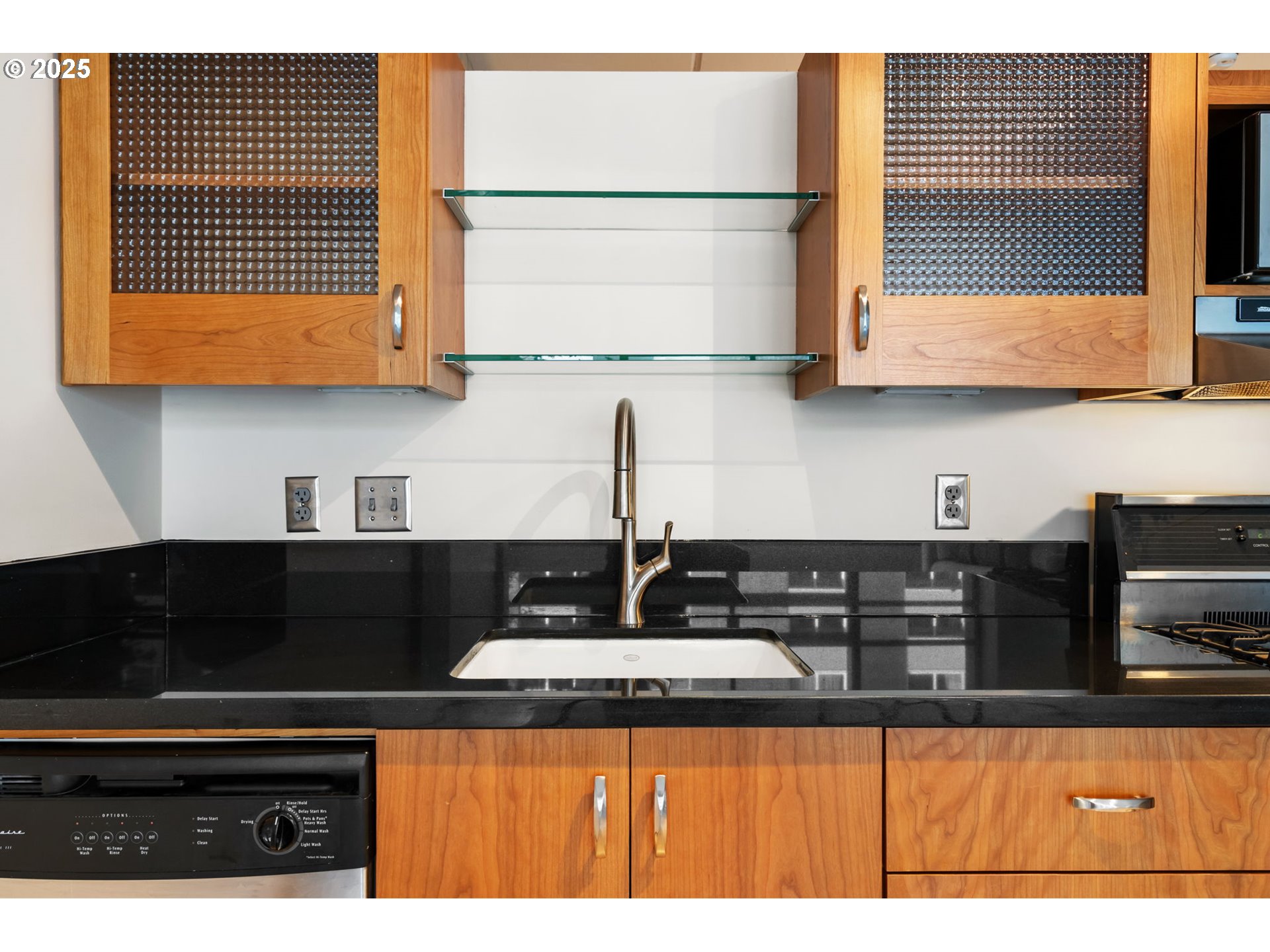 333 Northwest 9th Avenue, Unit 411 Portland, OR 97209 - Photo 17 of 32 a kitchen with stainless steel appliances granite countertop a sink a stove and a microwave