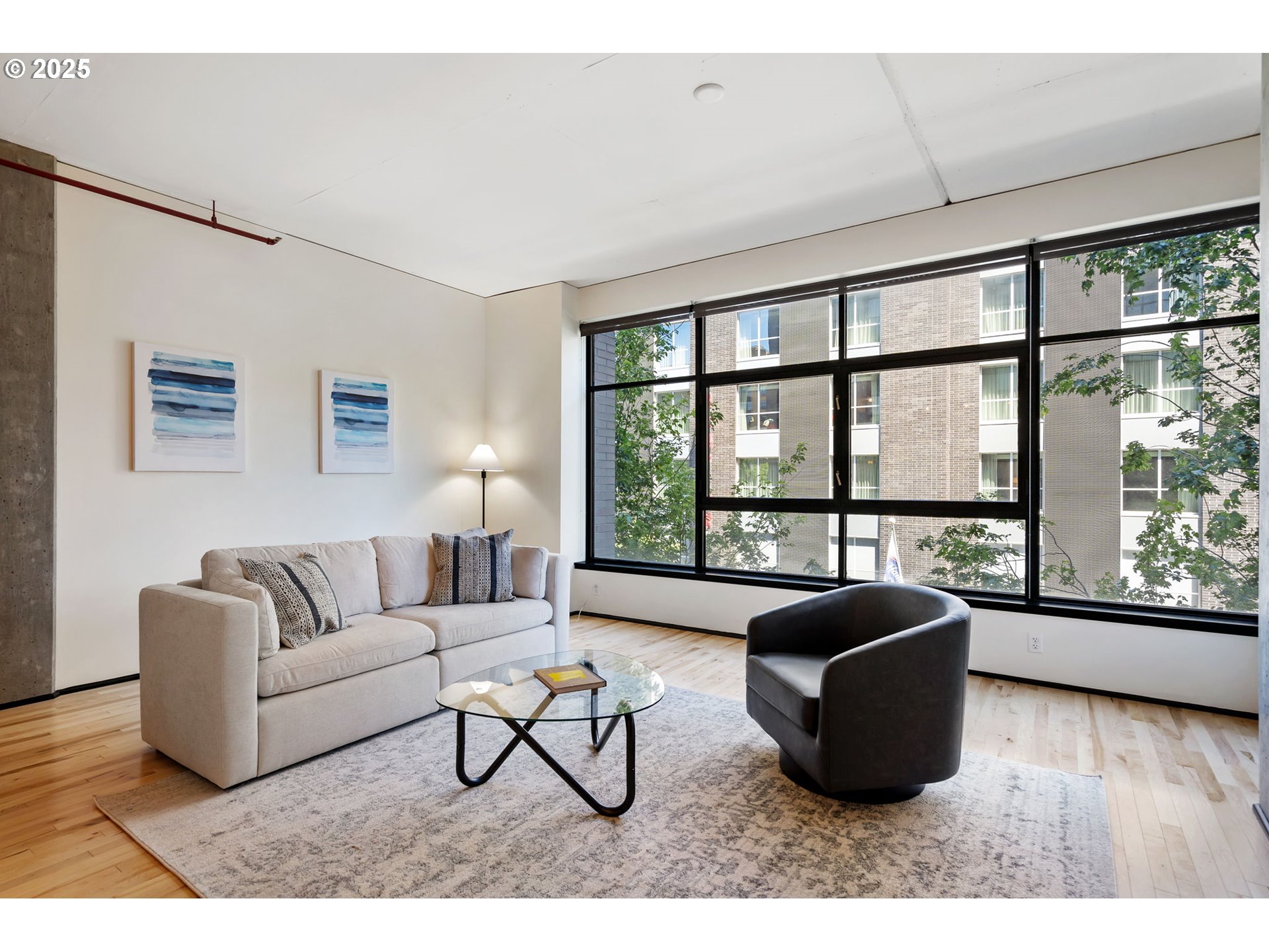 333 Northwest 9th Avenue, Unit 411 Portland, OR 97209 - Photo 7 of 32 a living room with furniture and a large window
