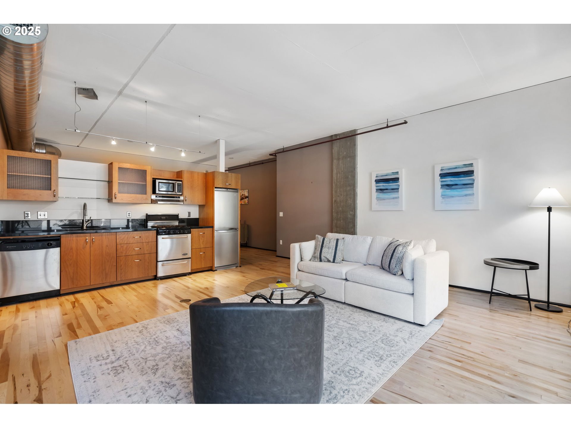 333 Northwest 9th Avenue, Unit 411 Portland, OR 97209 - Photo 8 of 32 a living room with stainless steel appliances kitchen island granite countertop furniture and a kitchen view