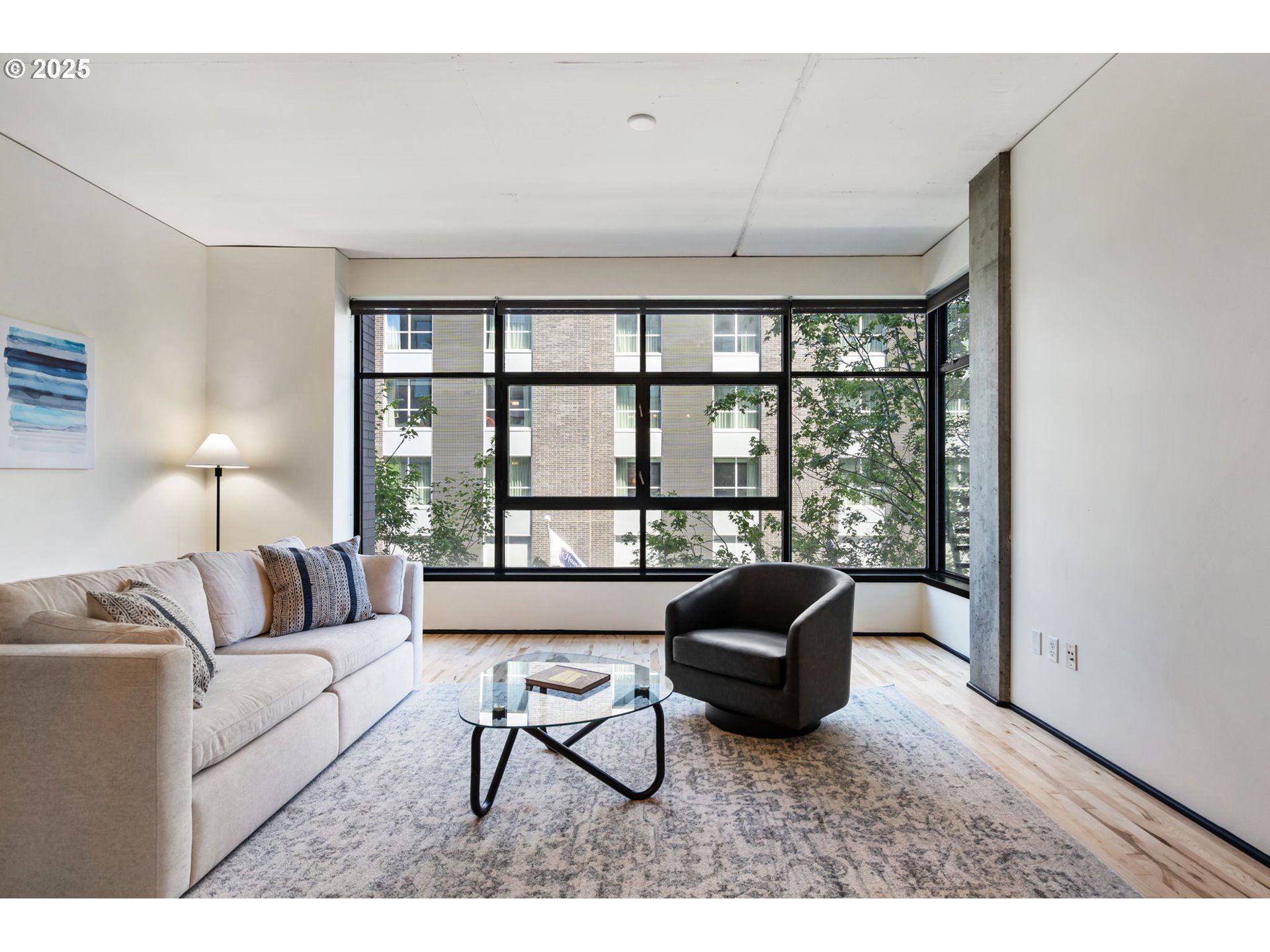 333 Northwest 9th Avenue, Unit 411 Portland, OR 97209 - Photo 10 of 32 a living room with furniture and a large window