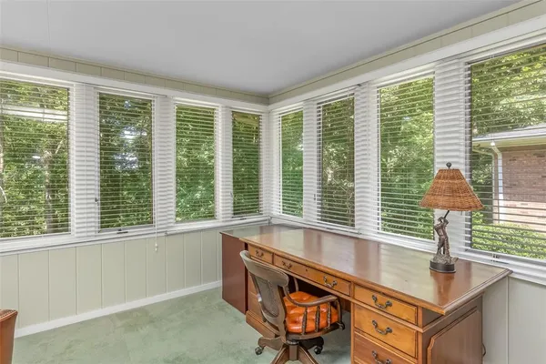 a room with pool table and windows