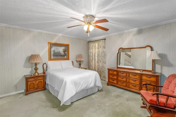 a bedroom with a bed chair and a chandelier