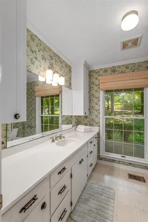 a bathroom with a sink and large window