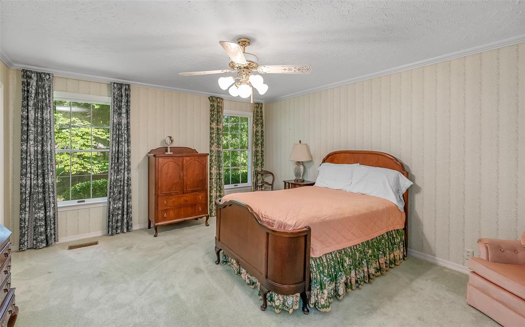741 Beverly Drive Homer, LA 71040 - Photo 18 of 30 a bedroom with a bed and a chandelier
