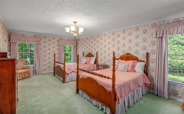 a bedroom with a bed and a chandelier