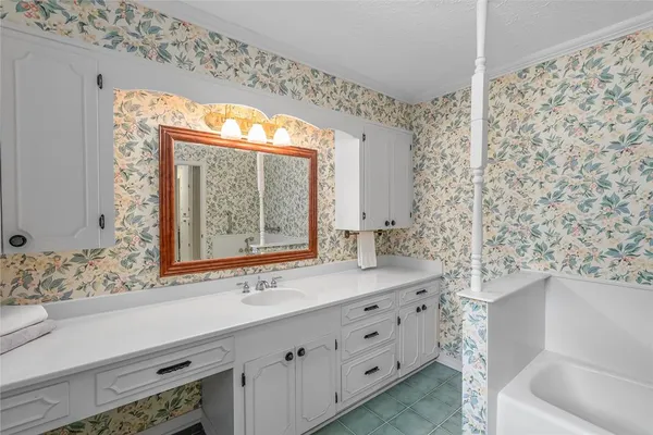 a bathroom with a sink and a large mirror