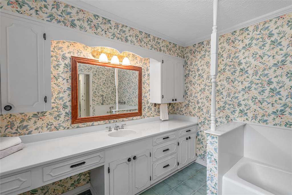 741 Beverly Drive Homer, LA 71040 - Photo 20 of 30 a bathroom with a sink and a large mirror