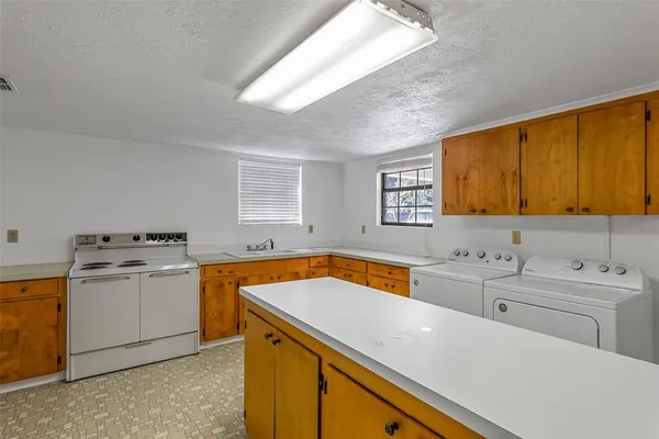 a view of a kitchen with sink and microwave