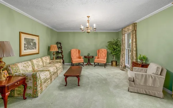 a living room with furniture and a chandelier