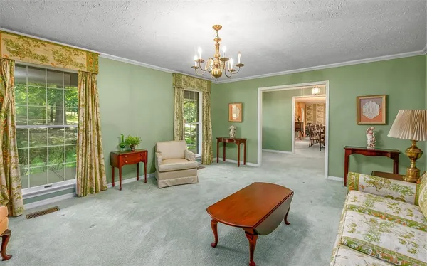 a living room with furniture and a chandelier