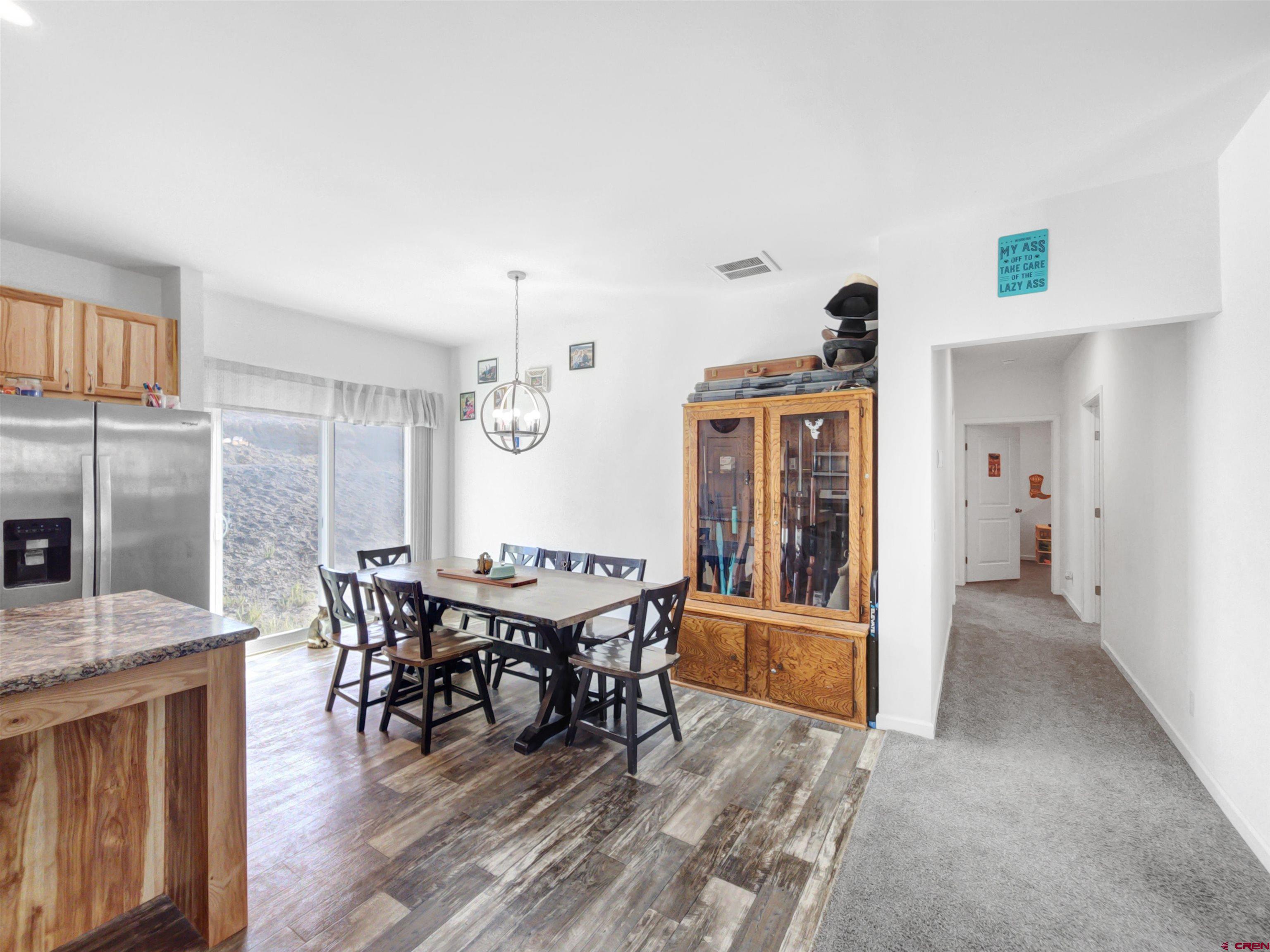 28454 Lampshire Road Hotchkiss, CO 81419 - Photo 1 of 45 a view of a dining room with furniture and wooden floor