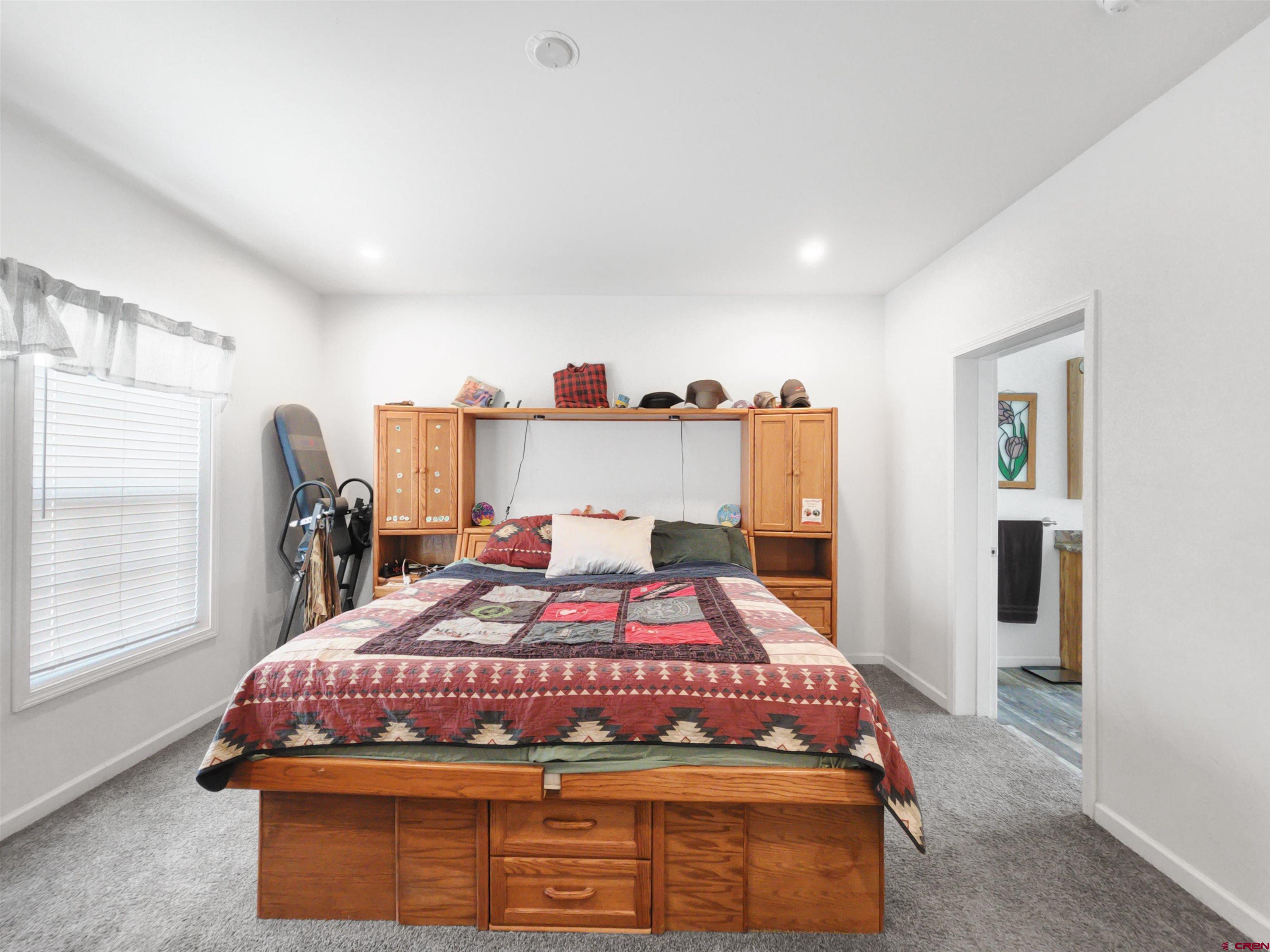 28454 Lampshire Road Hotchkiss, CO 81419 - Photo 11 of 45 a bedroom with a bed and window