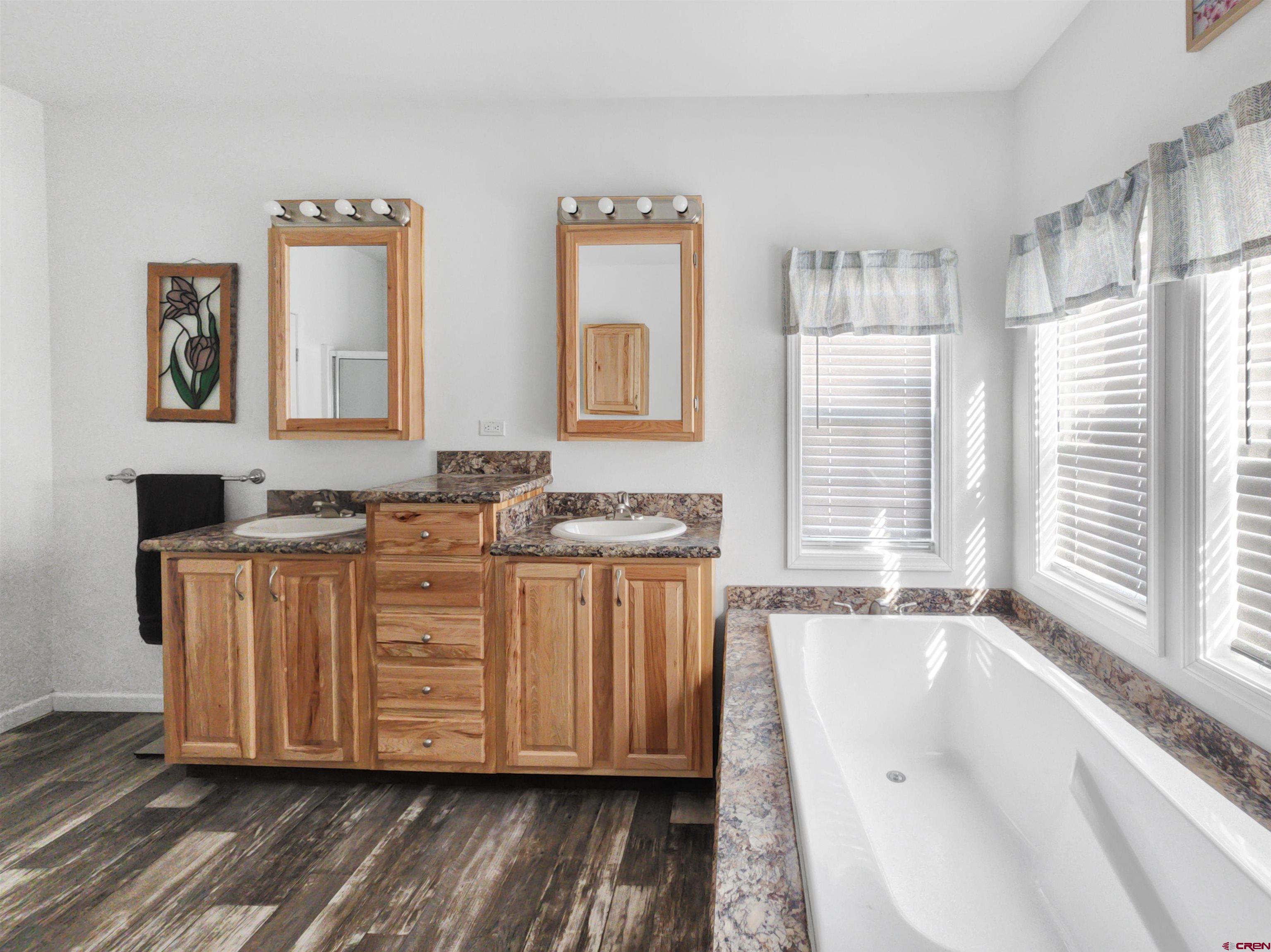 28454 Lampshire Road Hotchkiss, CO 81419 - Photo 12 of 45 a bathroom with a granite countertop sink and a large mirror