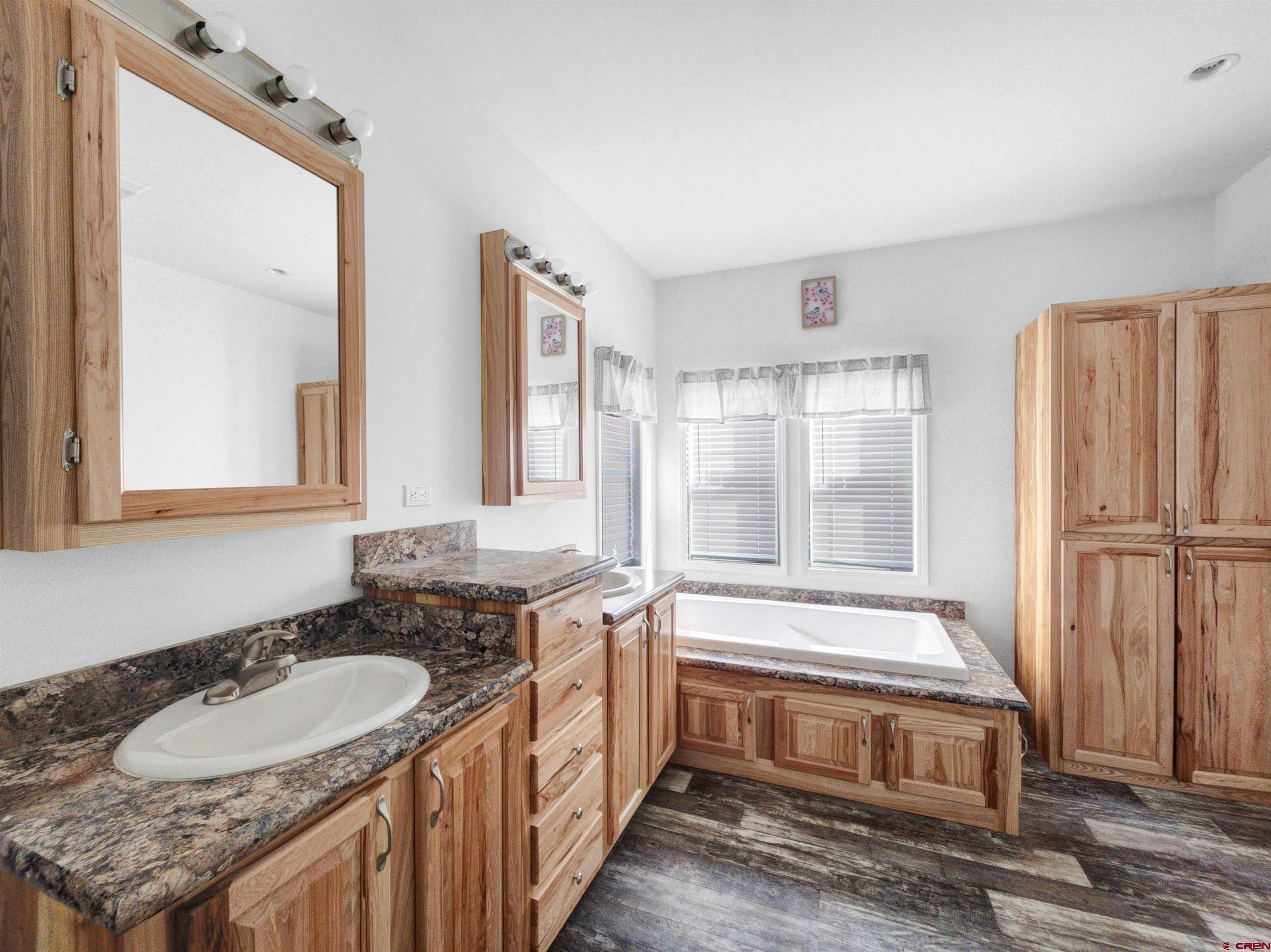 28454 Lampshire Road Hotchkiss, CO 81419 - Photo 14 of 45 a bathroom with a granite countertop sink and a mirror