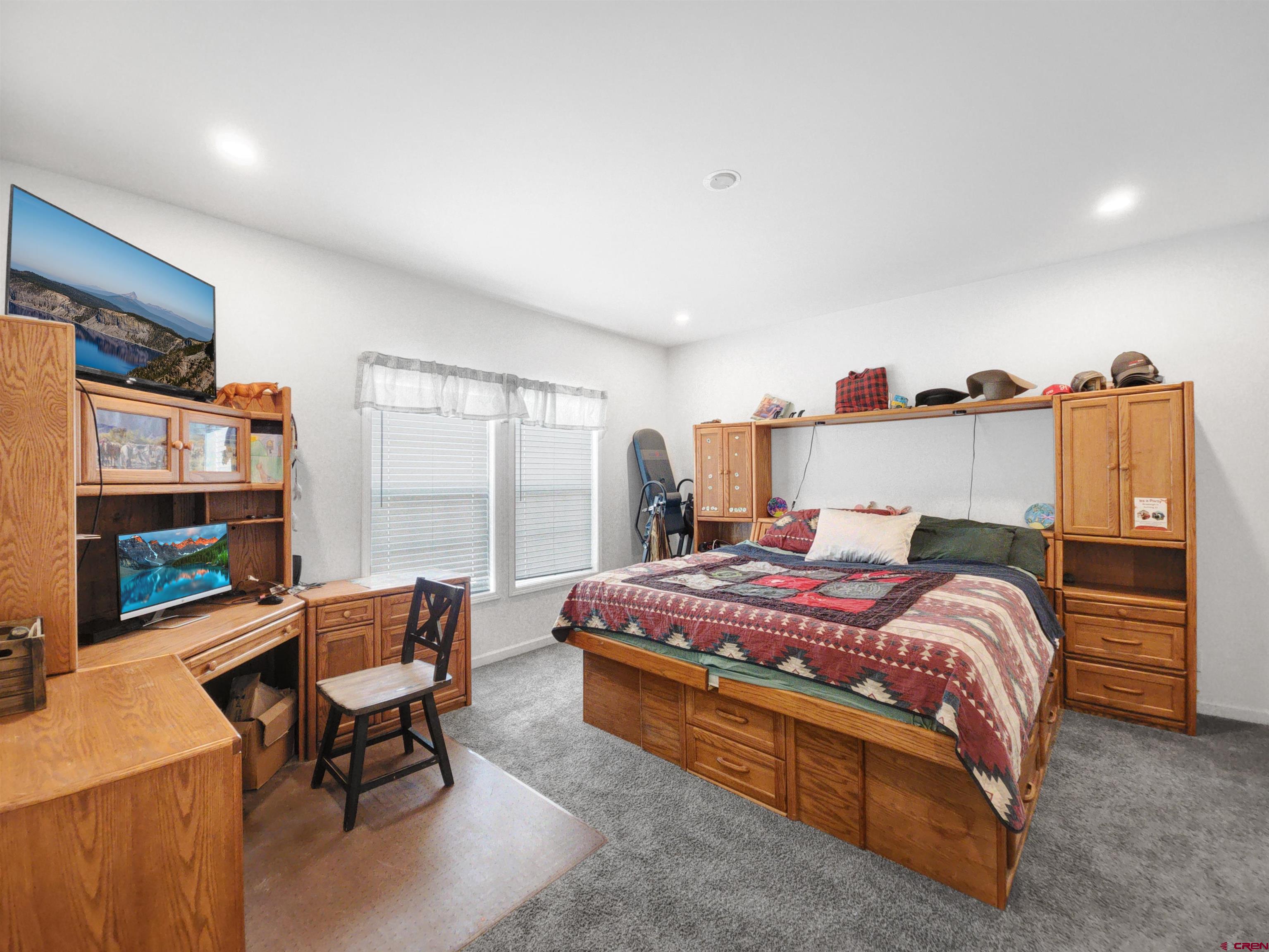 28454 Lampshire Road Hotchkiss, CO 81419 - Photo 15 of 45 a bedroom with a bed a desk and chair