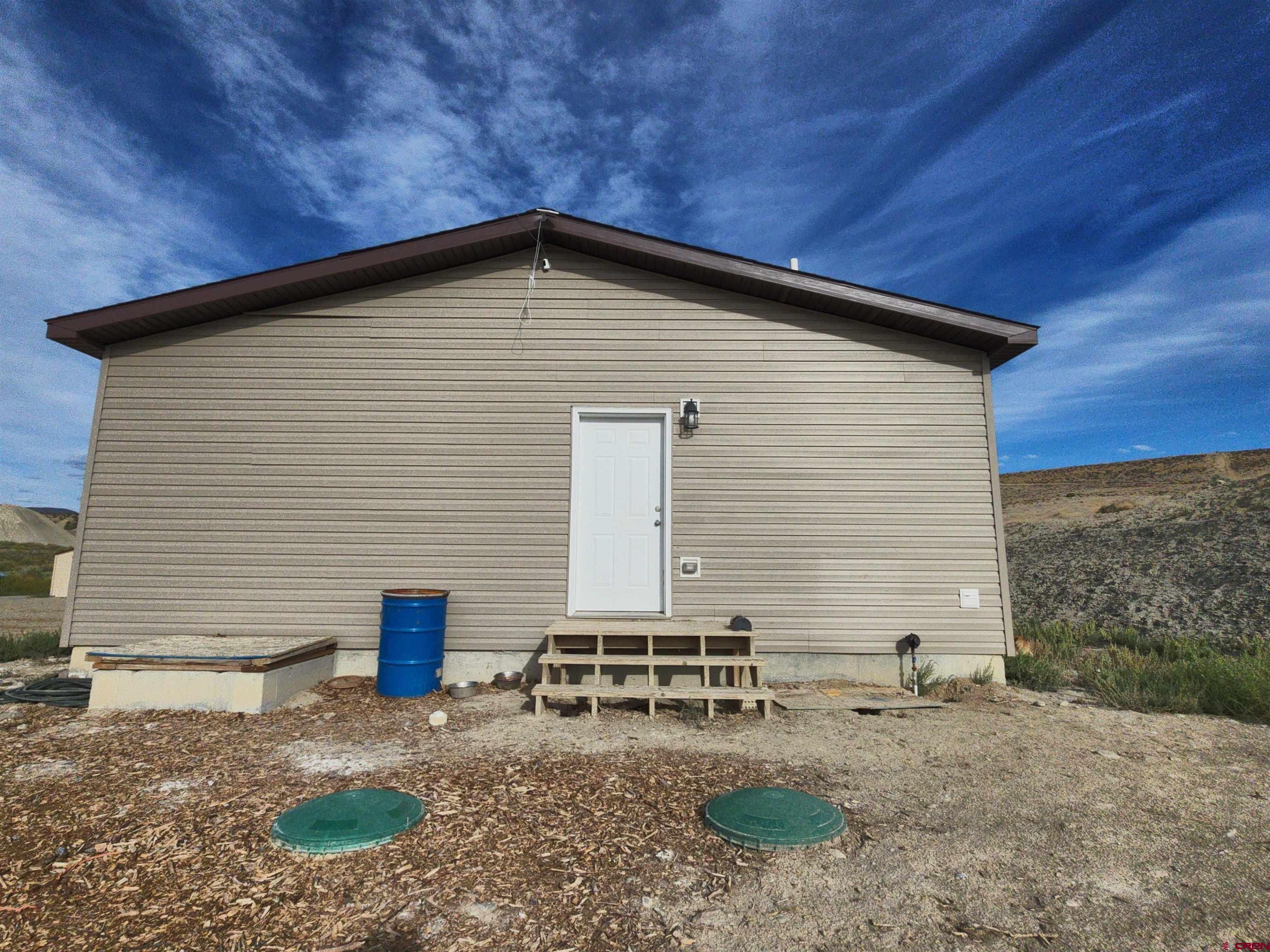 28454 Lampshire Road Hotchkiss, CO 81419 - Photo 17 of 45 a view of a house with a yard