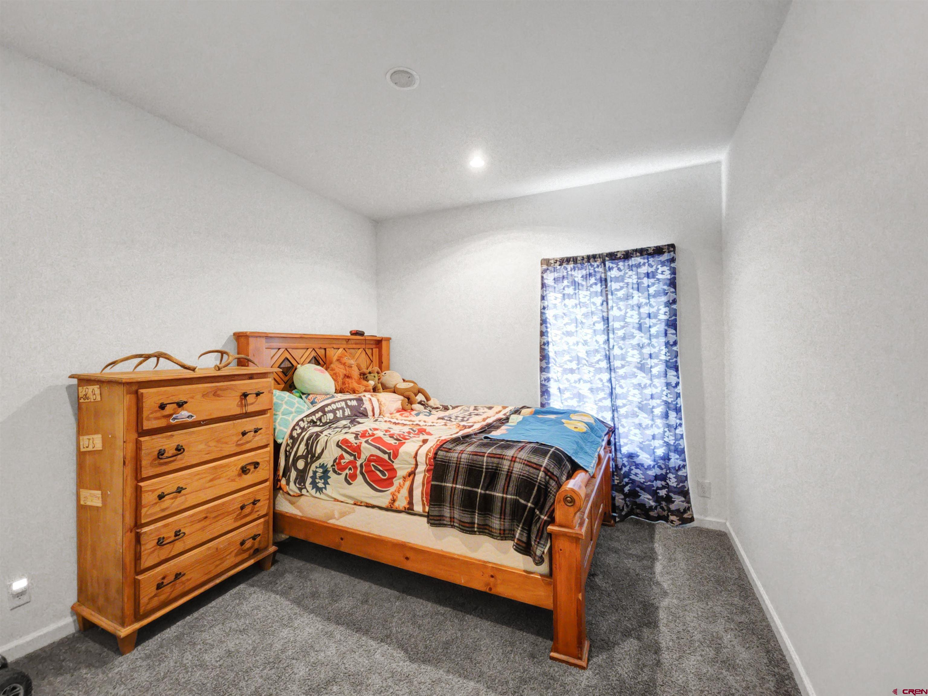 28454 Lampshire Road Hotchkiss, CO 81419 - Photo 21 of 45 a bed sitting in a room next to a lamp