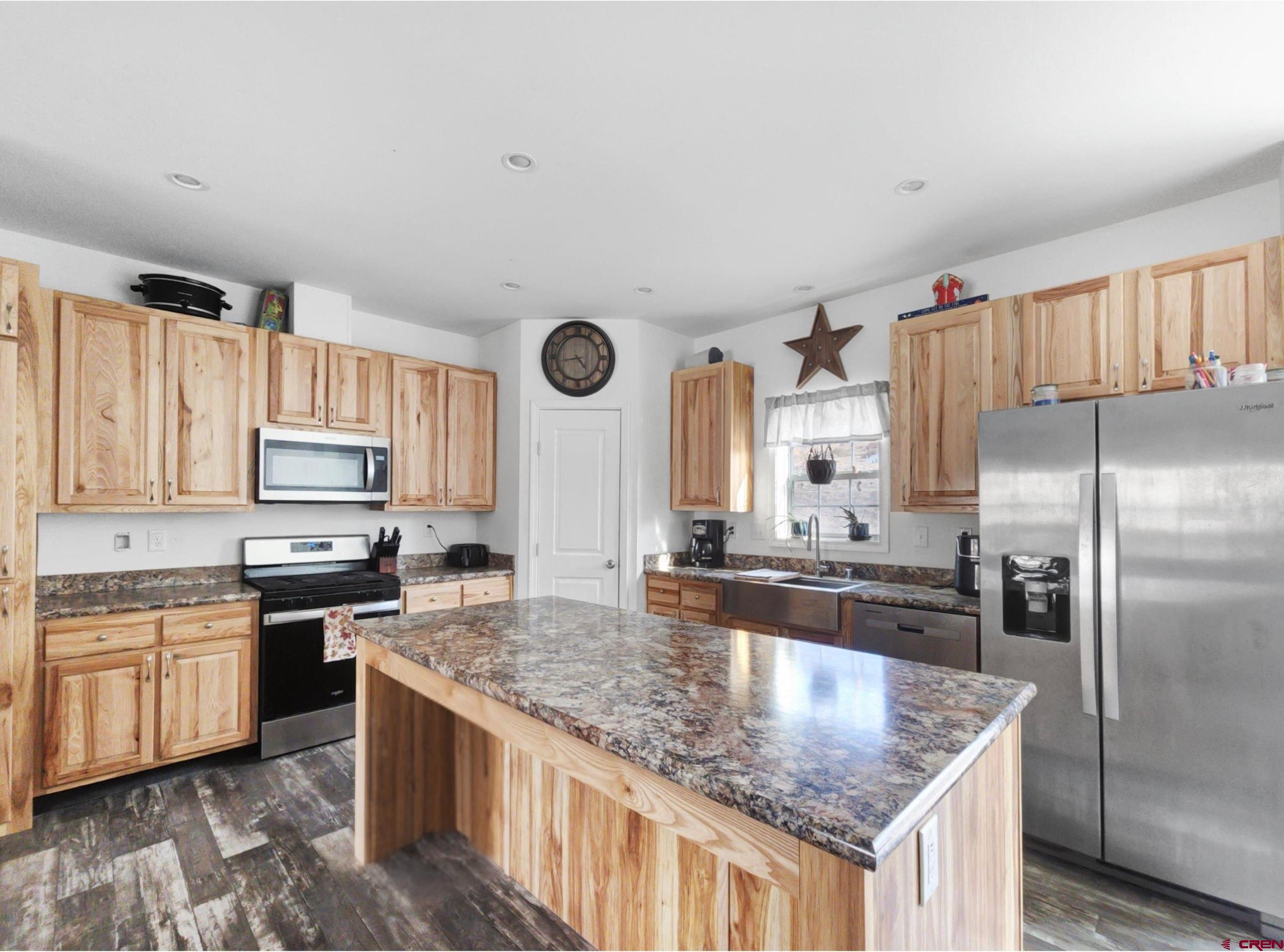 28454 Lampshire Road Hotchkiss, CO 81419 - Photo 6 of 45 a kitchen with stainless steel appliances granite countertop a sink stove and refrigerator