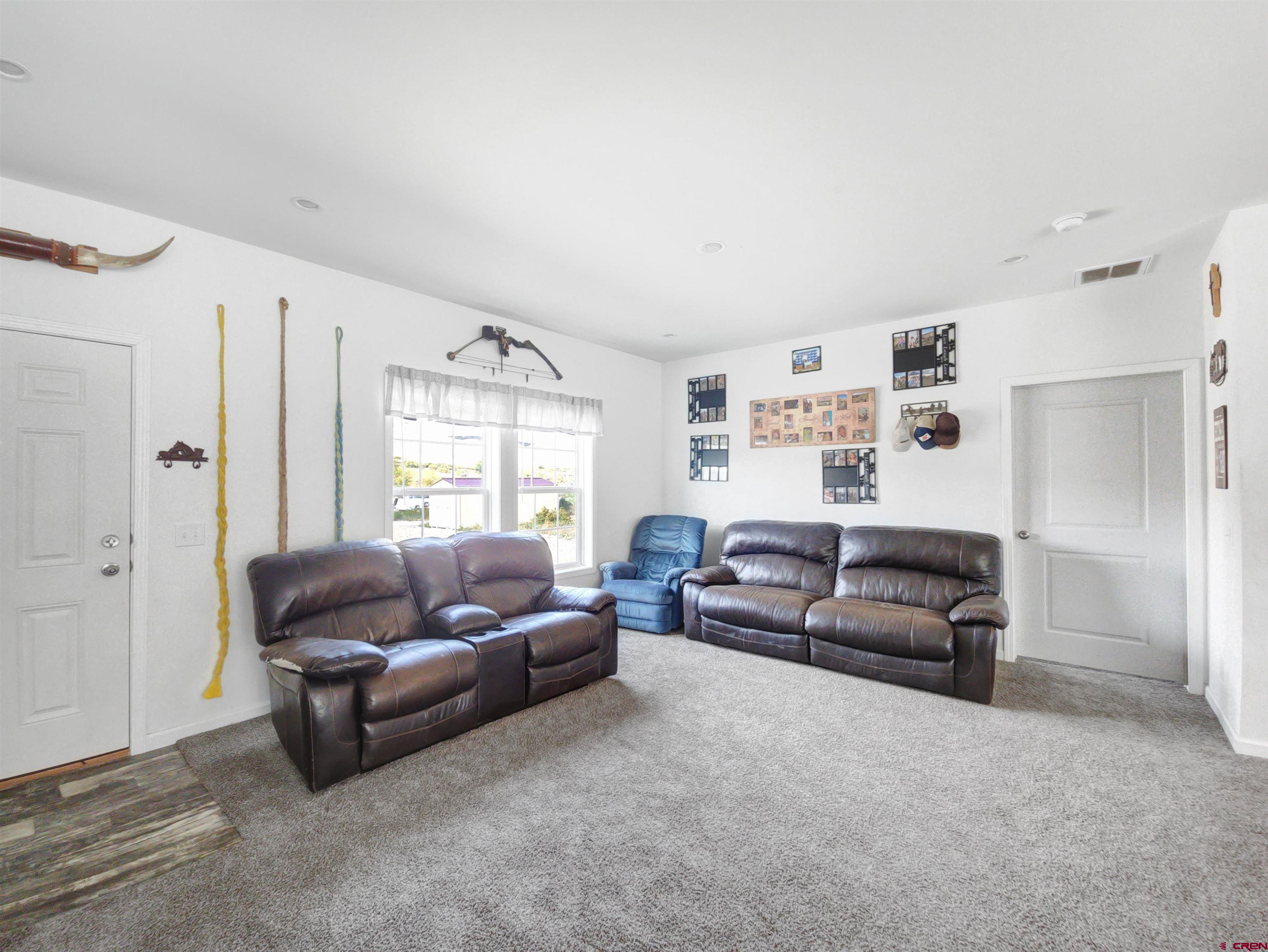 28454 Lampshire Road Hotchkiss, CO 81419 - Photo 8 of 45 a living room with furniture and a large window