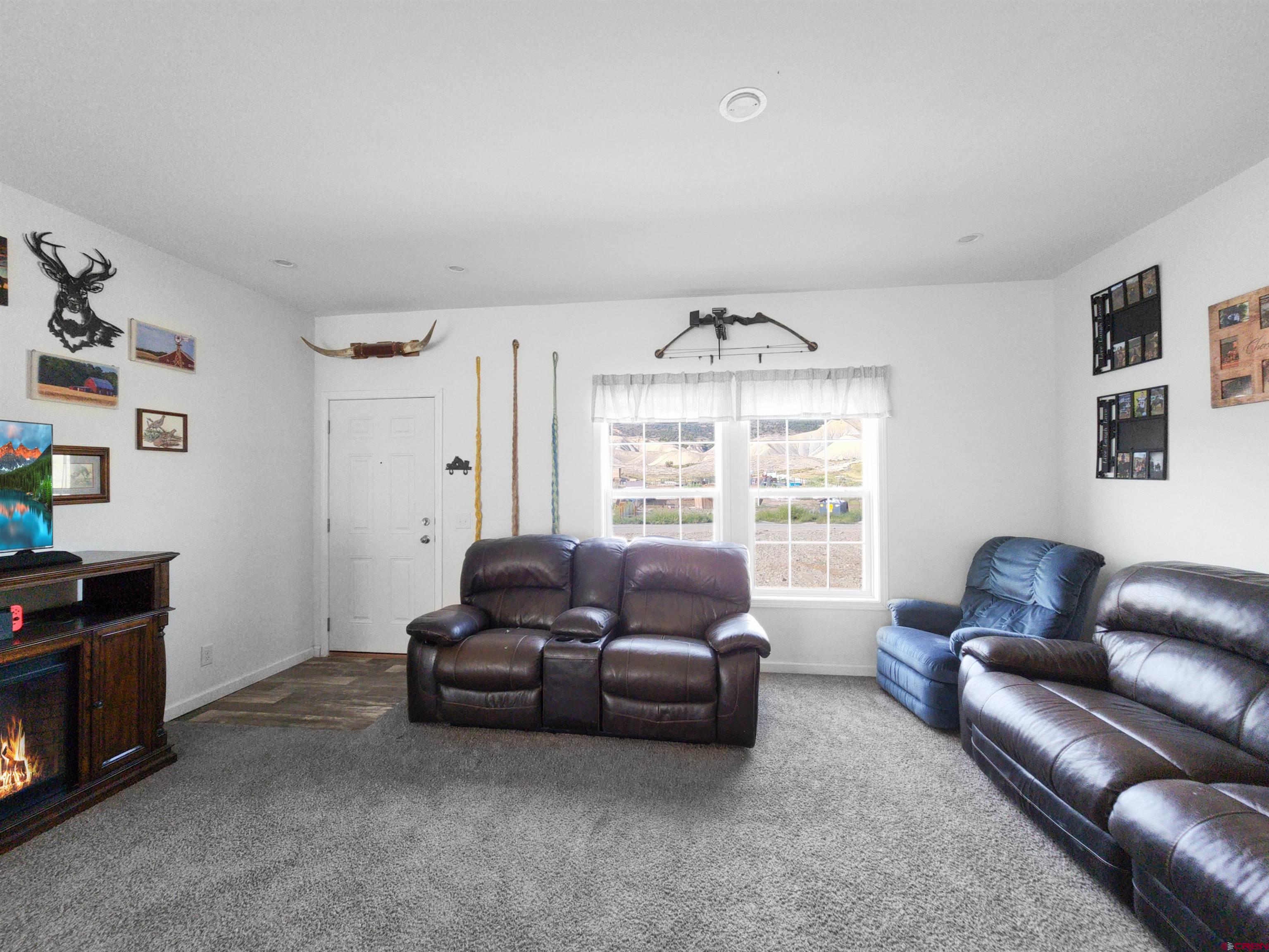 28454 Lampshire Road Hotchkiss, CO 81419 - Photo 9 of 45 a living room with furniture and a large window