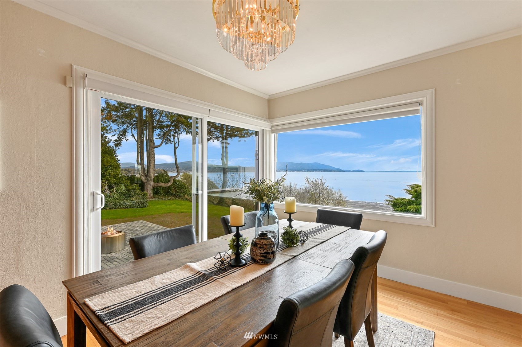 3796 Bancroft Road Bellingham, WA 98225 - Photo 12 of 38 a view of a dining room with furniture large windows and wooden floor