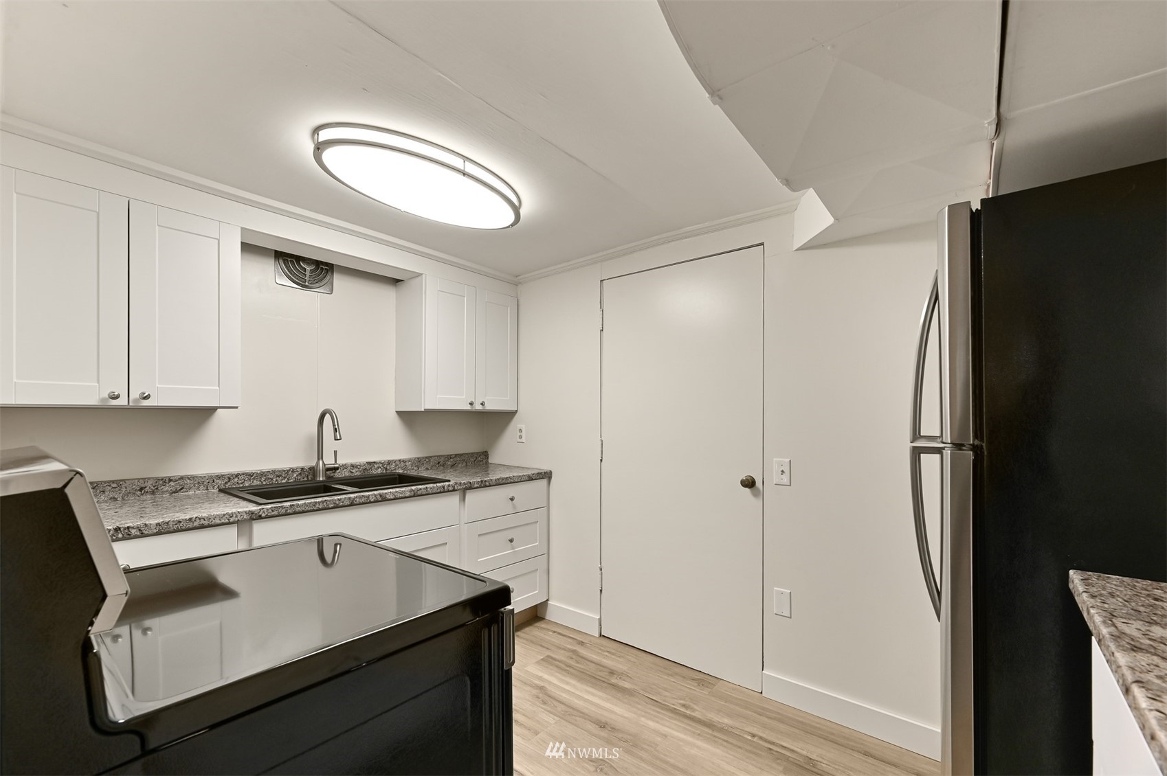 3796 Bancroft Road Bellingham, WA 98225 - Photo 28 of 38 a kitchen with stainless steel appliances granite countertop a refrigerator a sink and white cabinets