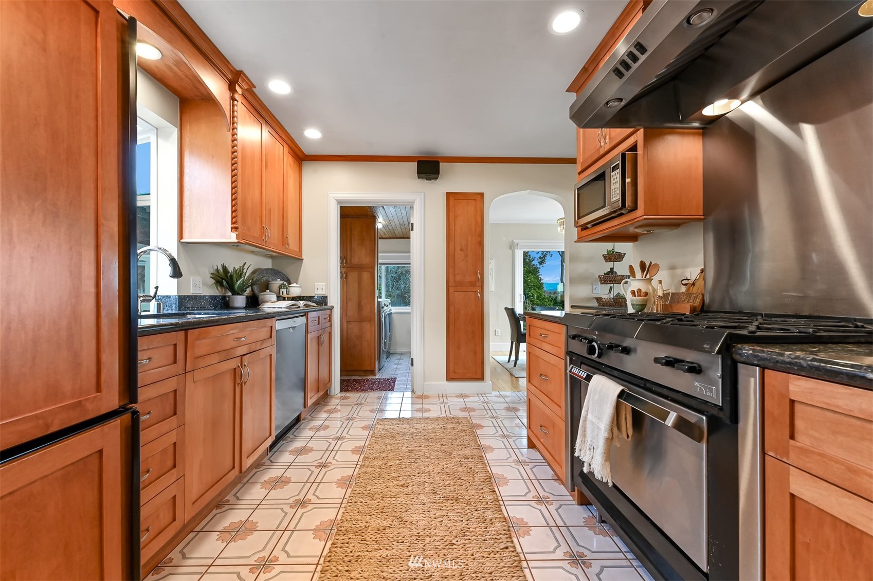3796 Bancroft Road Bellingham, WA 98225 - Photo 9 of 38 a kitchen with stainless steel appliances granite countertop a stove a sink and a refrigerator