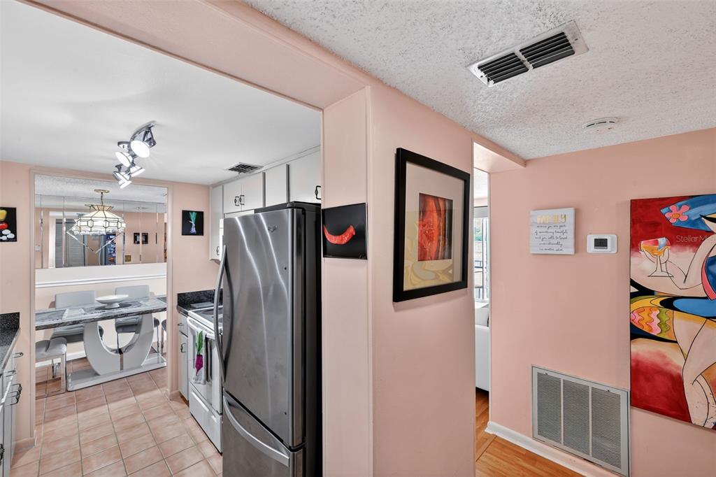 5541 Bay Boulevard, Unit 203 Port Richey, FL 34668 - Photo 11 of 30 a kitchen with stainless steel appliances granite countertop a refrigerator and a sink