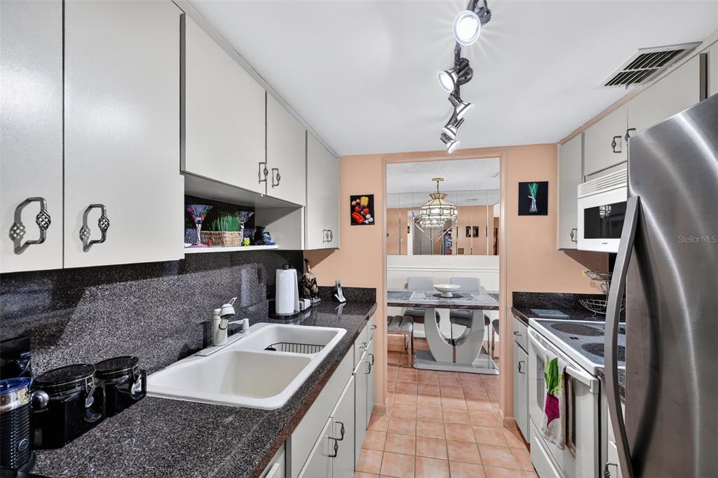 5541 Bay Boulevard, Unit 203 Port Richey, FL 34668 - Photo 12 of 30 a kitchen with a sink stove and refrigerator