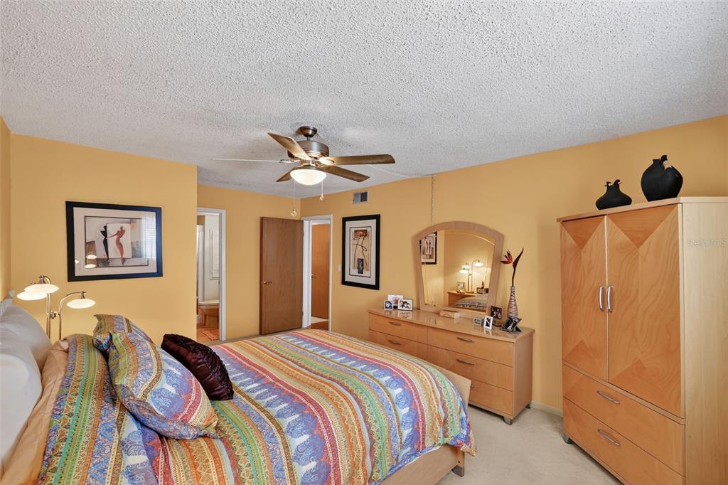 5541 Bay Boulevard, Unit 203 Port Richey, FL 34668 - Photo 16 of 30 a bedroom with a bed and a chandelier