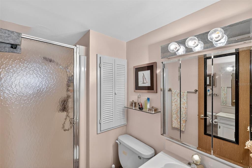 5541 Bay Boulevard, Unit 203 Port Richey, FL 34668 - Photo 18 of 30 a spacious bathroom with a shower a toilet and a sink