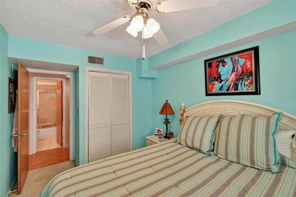 5541 Bay Boulevard, Unit 203 Port Richey, FL 34668 - Photo 20 of 30 a bedroom with a bed and a chandelier