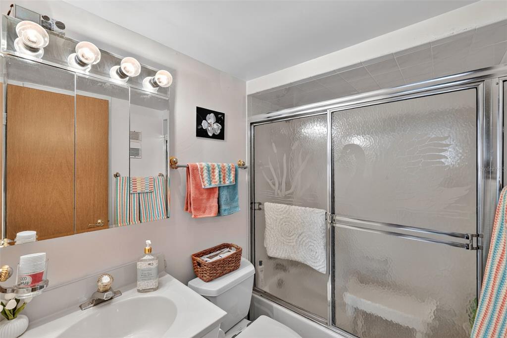 5541 Bay Boulevard, Unit 203 Port Richey, FL 34668 - Photo 21 of 30 a bathroom with a sink mirror vanity and toilet