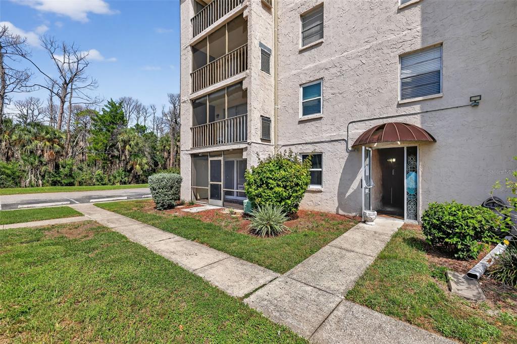5541 Bay Boulevard, Unit 203 Port Richey, FL 34668 - Photo 24 of 30 a front view of a house with garden