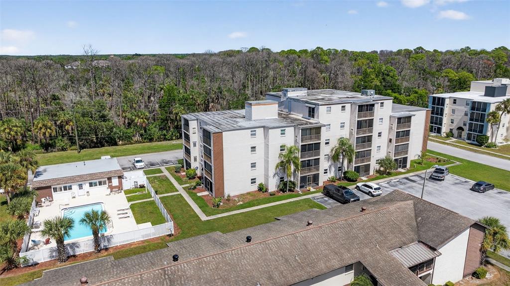 5541 Bay Boulevard, Unit 203 Port Richey, FL 34668 - Photo 26 of 30 an aerial view of a house with a garden and mountain view